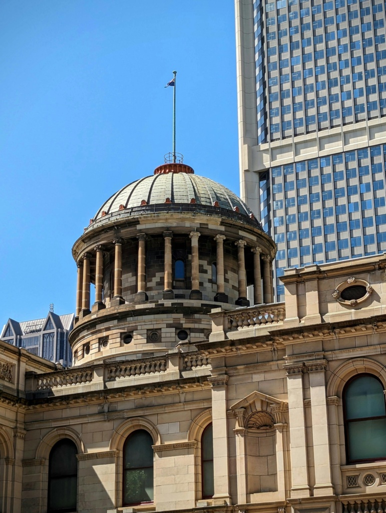 Iconic dome of the Supreme Court of Victoria in Melbourne under clear blue skies.