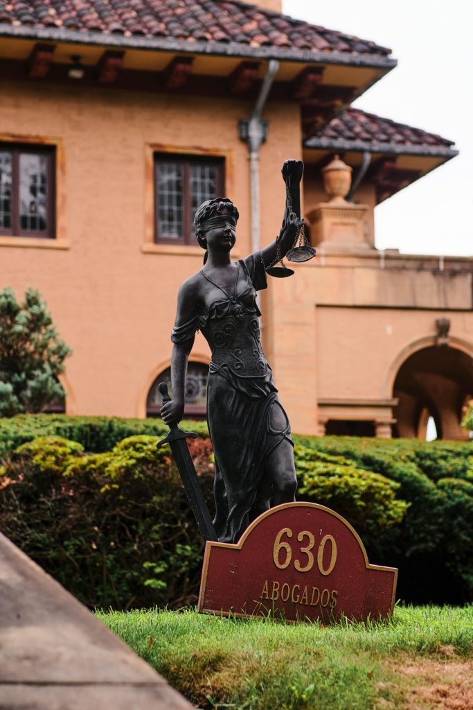 pexels-photo-28173139-28173139 Bronze Lady Justice statue at Arizona law firm's entrance, symbolizing fairness.