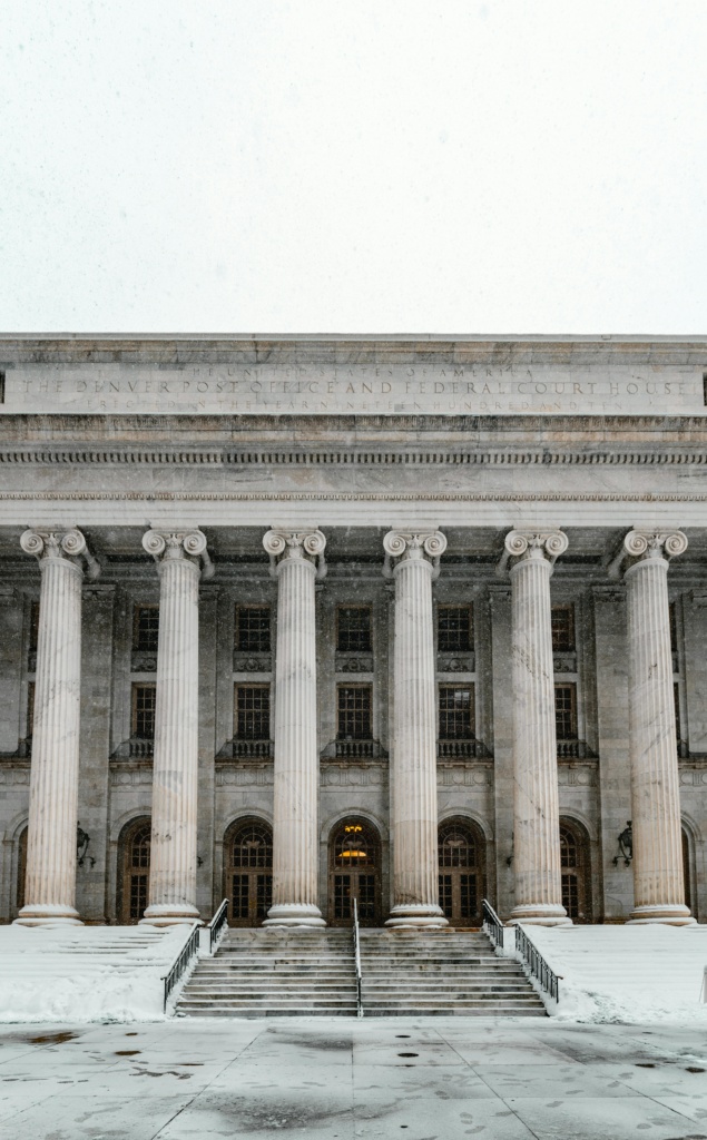 pexels-photo-3751006-3751006 Majestic courthouse facade with columns and stairs blanketed in snow, capturing Denver's winter charm.