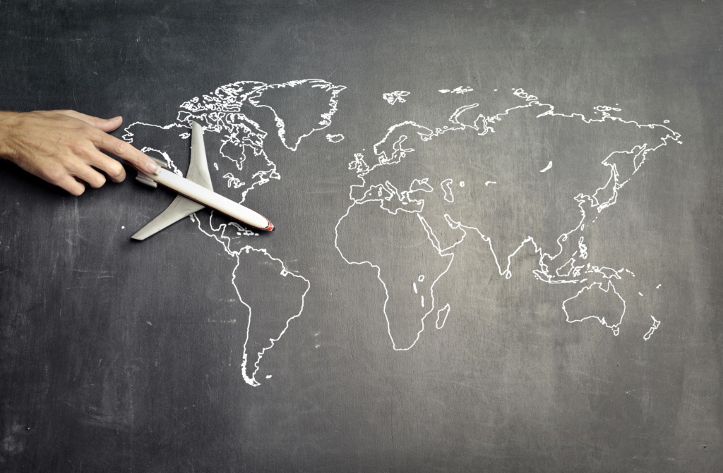 pexels-photo-3769146-3769146 From above of crop anonymous person driving toy airplane on empty world map drawn on blackboard representing travel concept