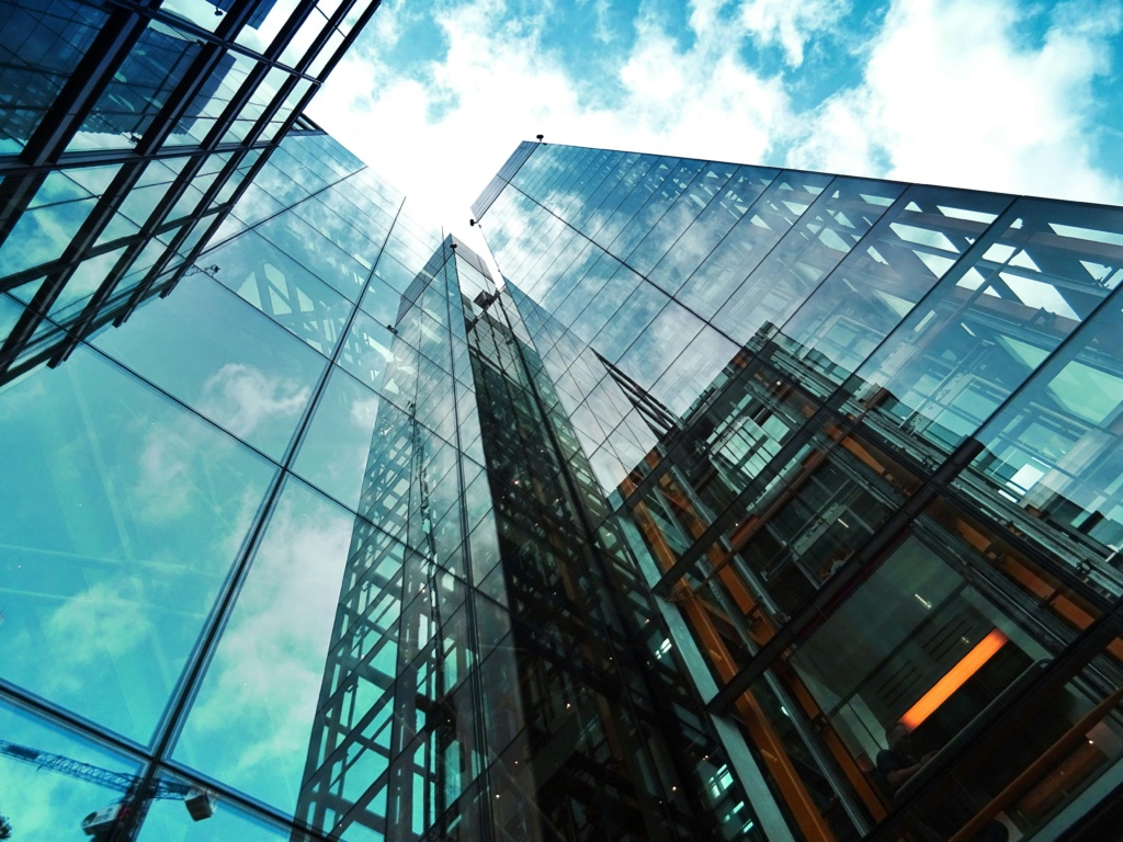 pexels-photo-443383-443383 A striking view of a modern glass skyscraper reflecting the sky and clouds.
